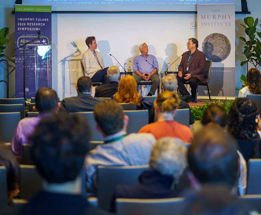 Tulane professors Nicholas Mattei (left) and Walter Isaacson (center) talk with Michael Littman (right) on stage after his Keynote speech at the 2026 Murphy-Tulane Research Symposium.