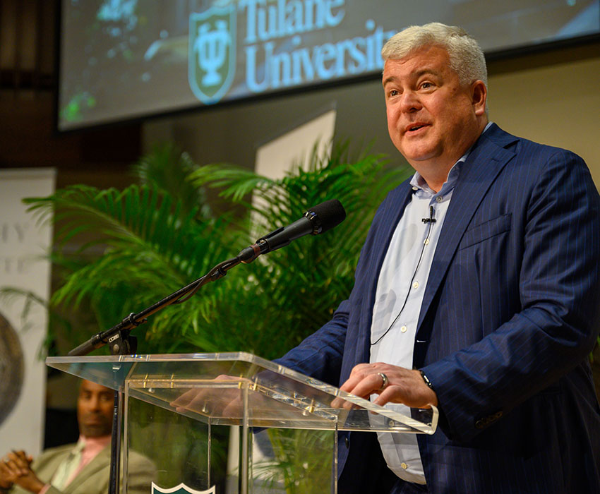 Dan Gallagher speaks at the 2025 Yates Lecture with Tulane University logo.