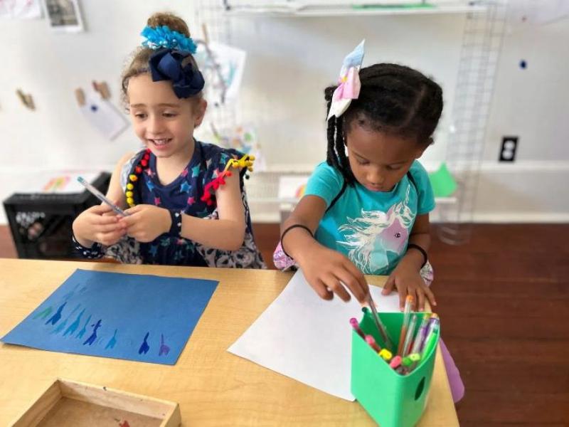 two preschool girls drawing