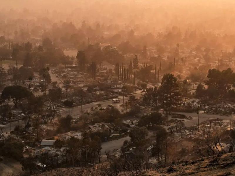 smoke lingers over a neighborhood in Altadena California