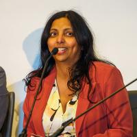 Anjana Susarla speaks into a microphone at a panel.