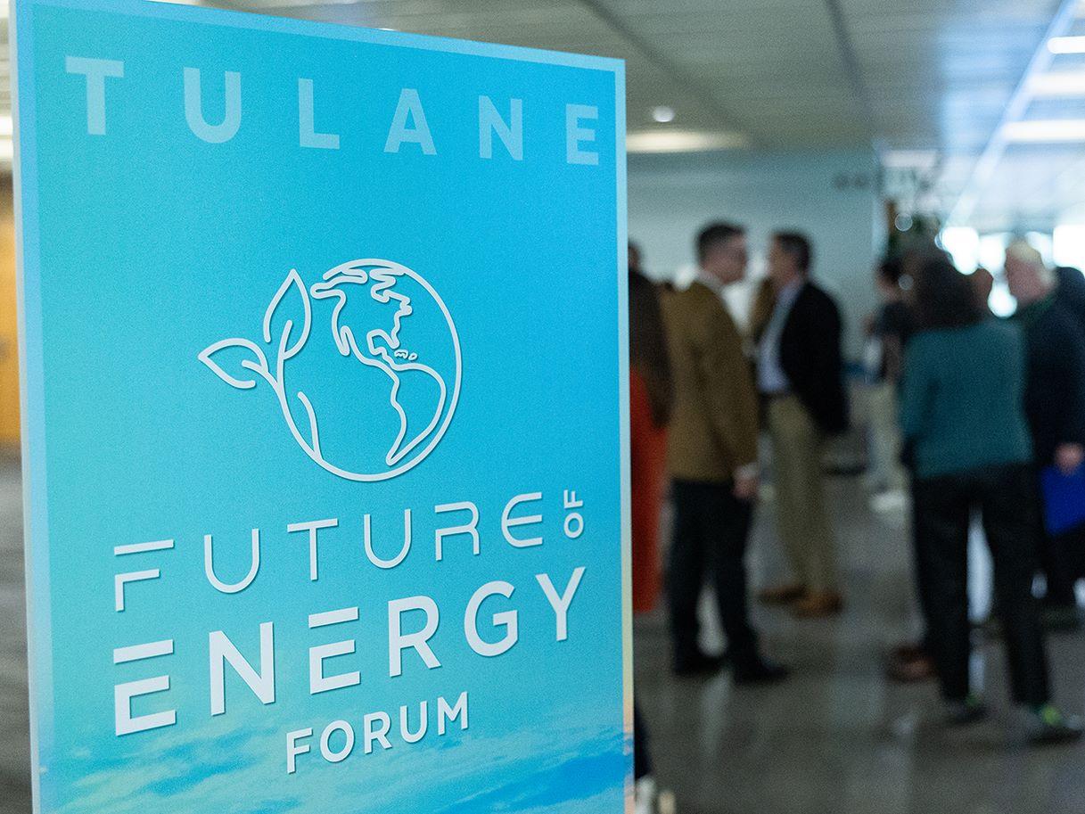 blue energy forum sign with attendees gathered in background