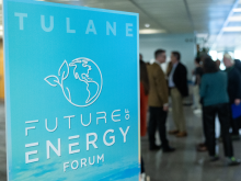 blue energy forum sign with attendees gathered in background