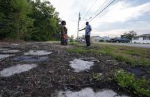 A man and a woman alongside the IMTT facility in St. Rose, LA