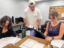 Undergraduate students copy and scan documents for the database on housing segregation
