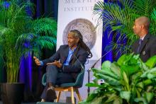 Dr. Carl Hart speaking at the Center for Ethics Fall 2025 Public Lecture seated next to Executive Director Gary "Hoov" Hoover suit