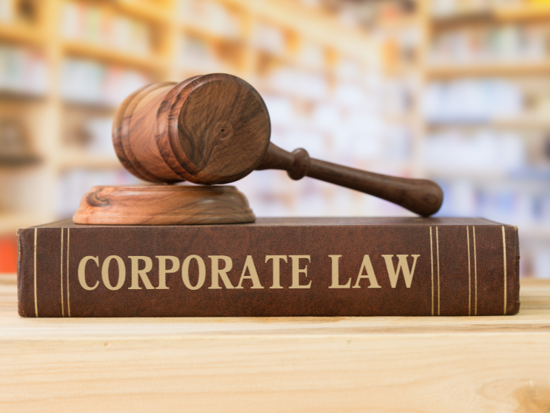 A gavel rests atop a corporate law book