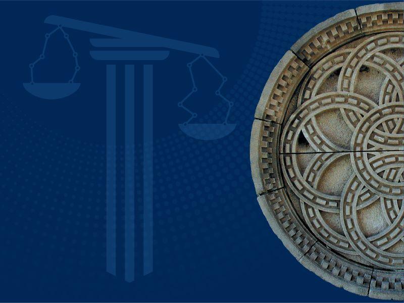 scales of justice and murphy rosette on a blue background